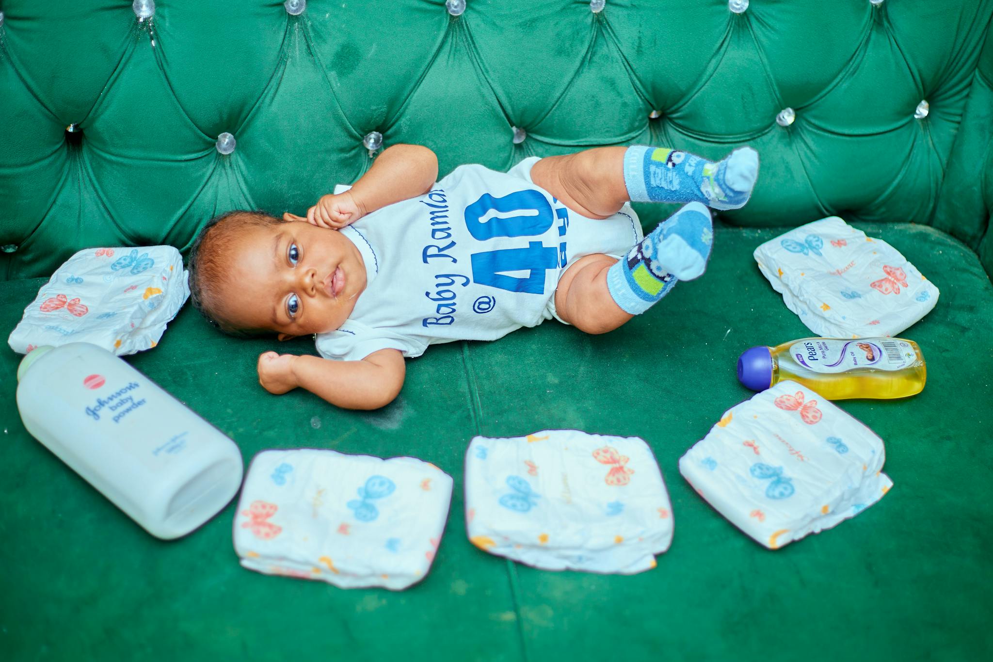 Cute Baby Lying On A Green Couch Cute baby lying on a green couch